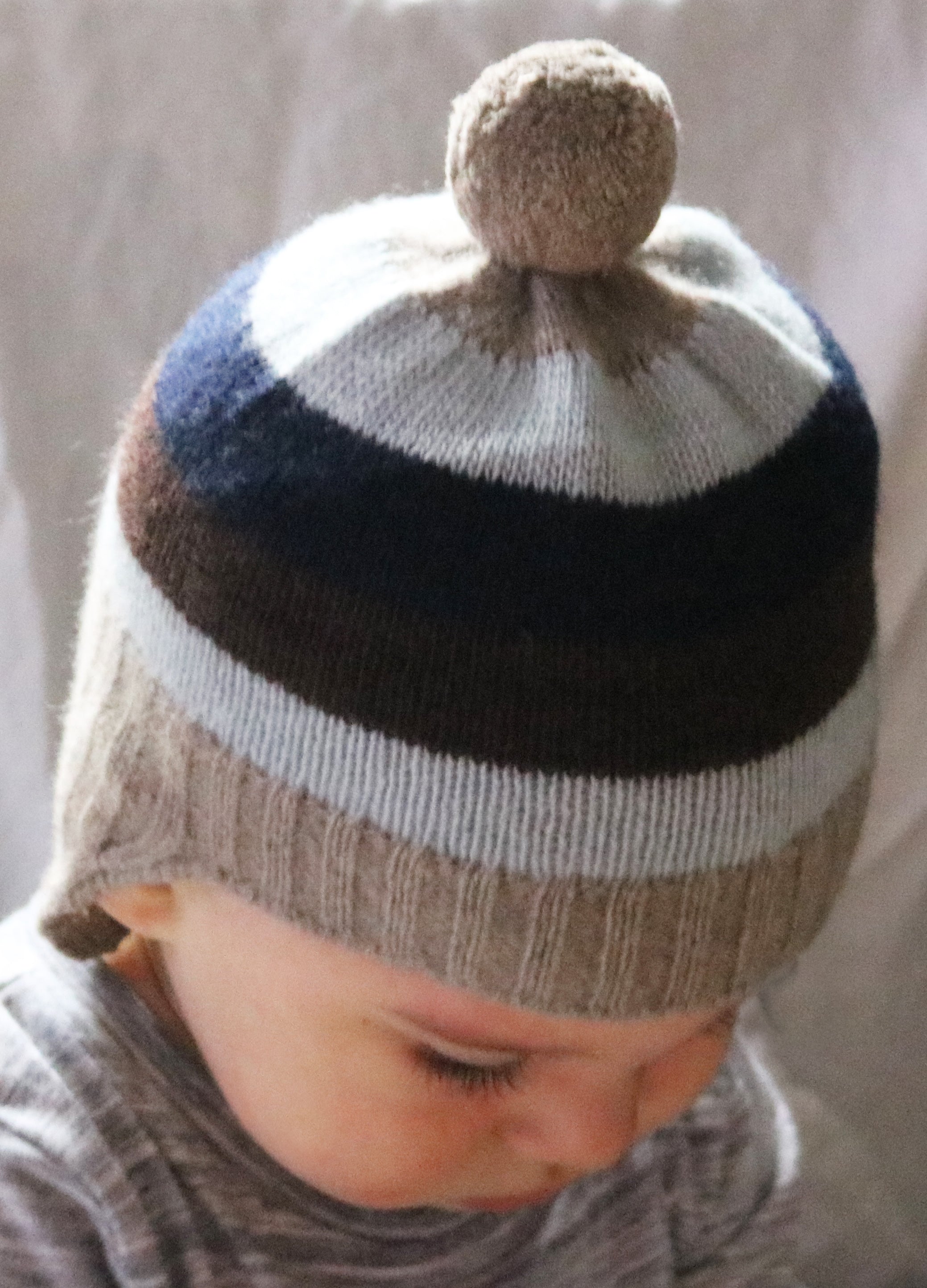 BABY STRIPED EARFLAP WITH POM POM
